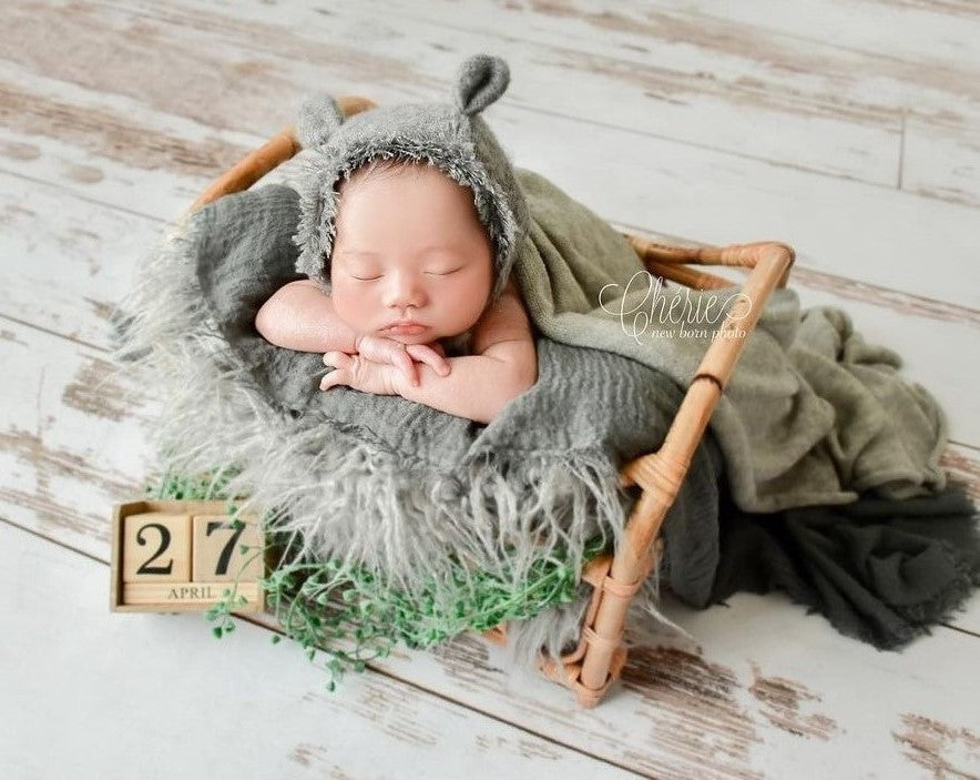Baby lying on wooden mat