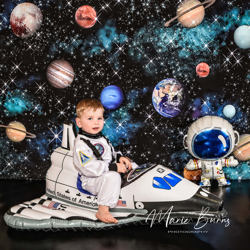 Boy sitting on a toy plane flying in space