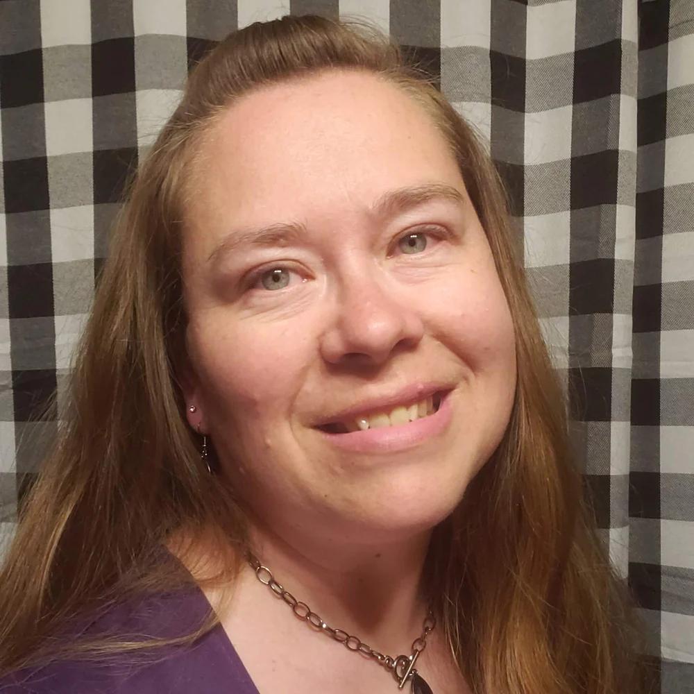 Kate backdrop designer in front of black and white checkered backdrop