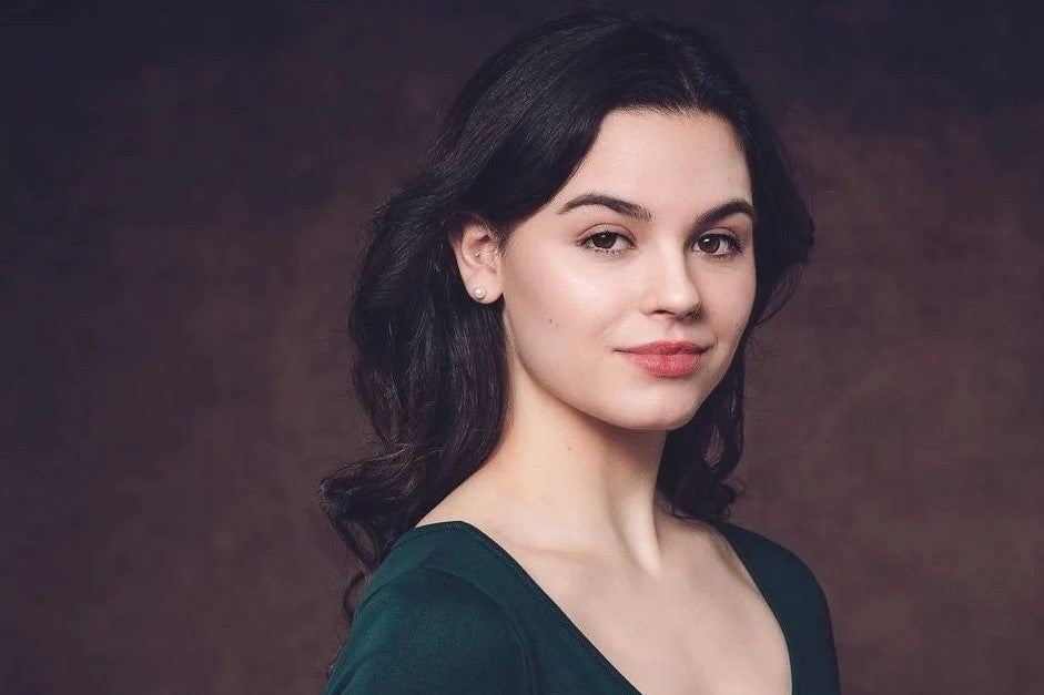 Girl standing in front of abstract backdrop