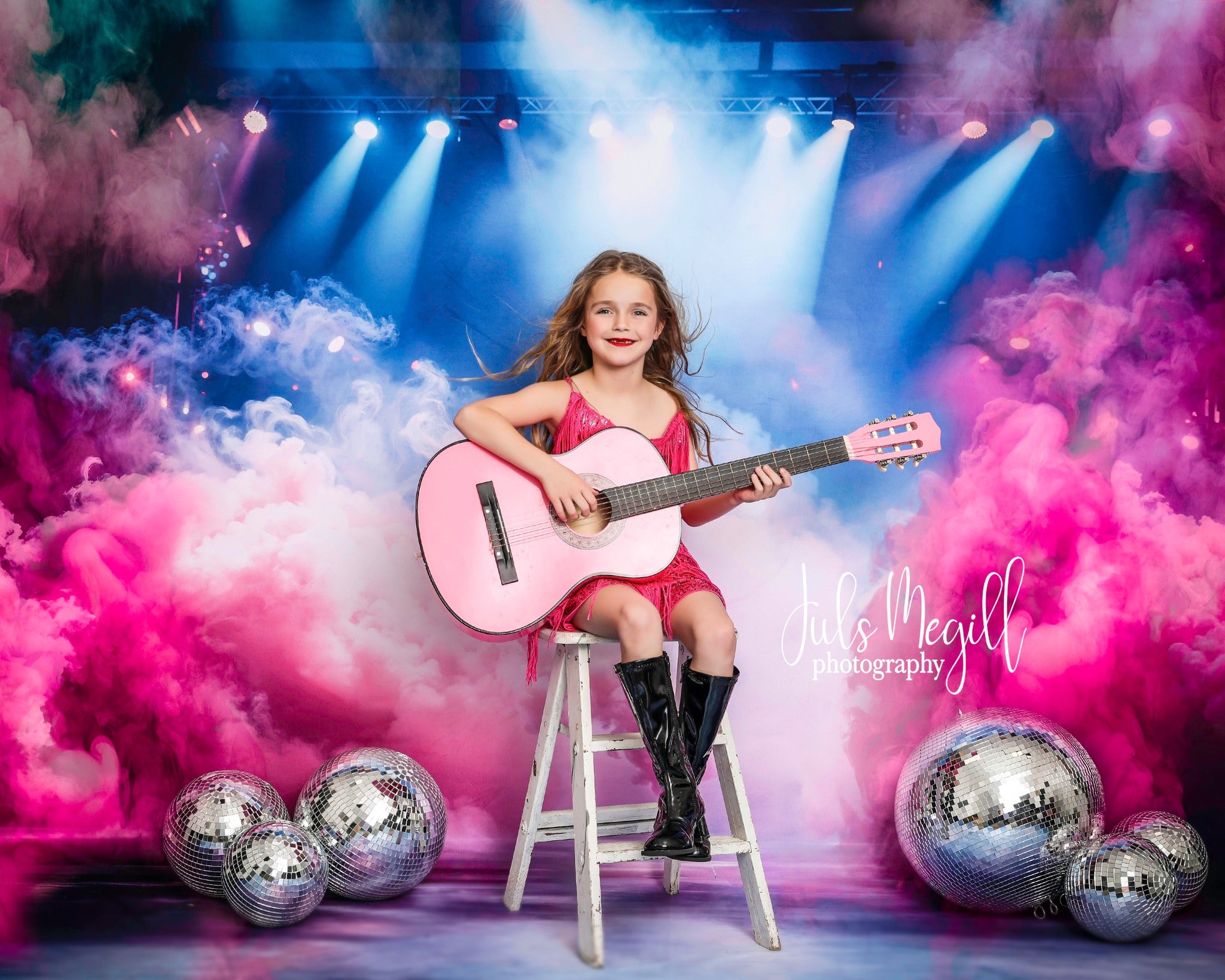 Girl holding guitar in Pink Atmosphere Smoke Light Sitting in front of Stage Backdrop
