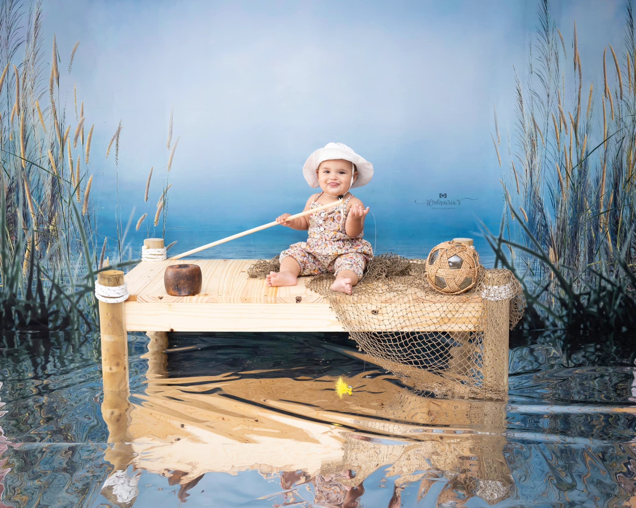 Boy holding fishing rod in front of Reed Cloudy Sky Lake Backdrop