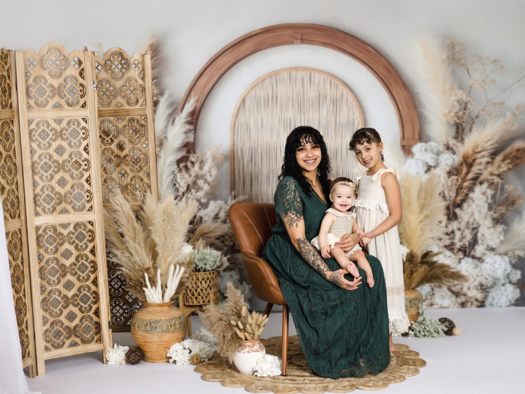 Three brothers sitting in front of blue floral boho backdrop
