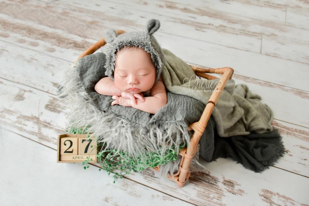 Baby sleeping on the wooden floor