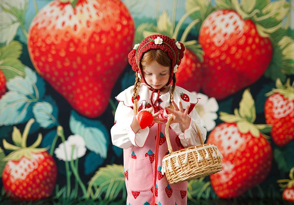 A girl wearing a headscarf is picking strawberries with a bamboo basket
