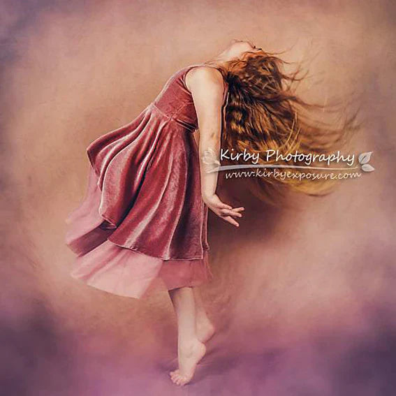 Dancing girl in front of abstract backdrop