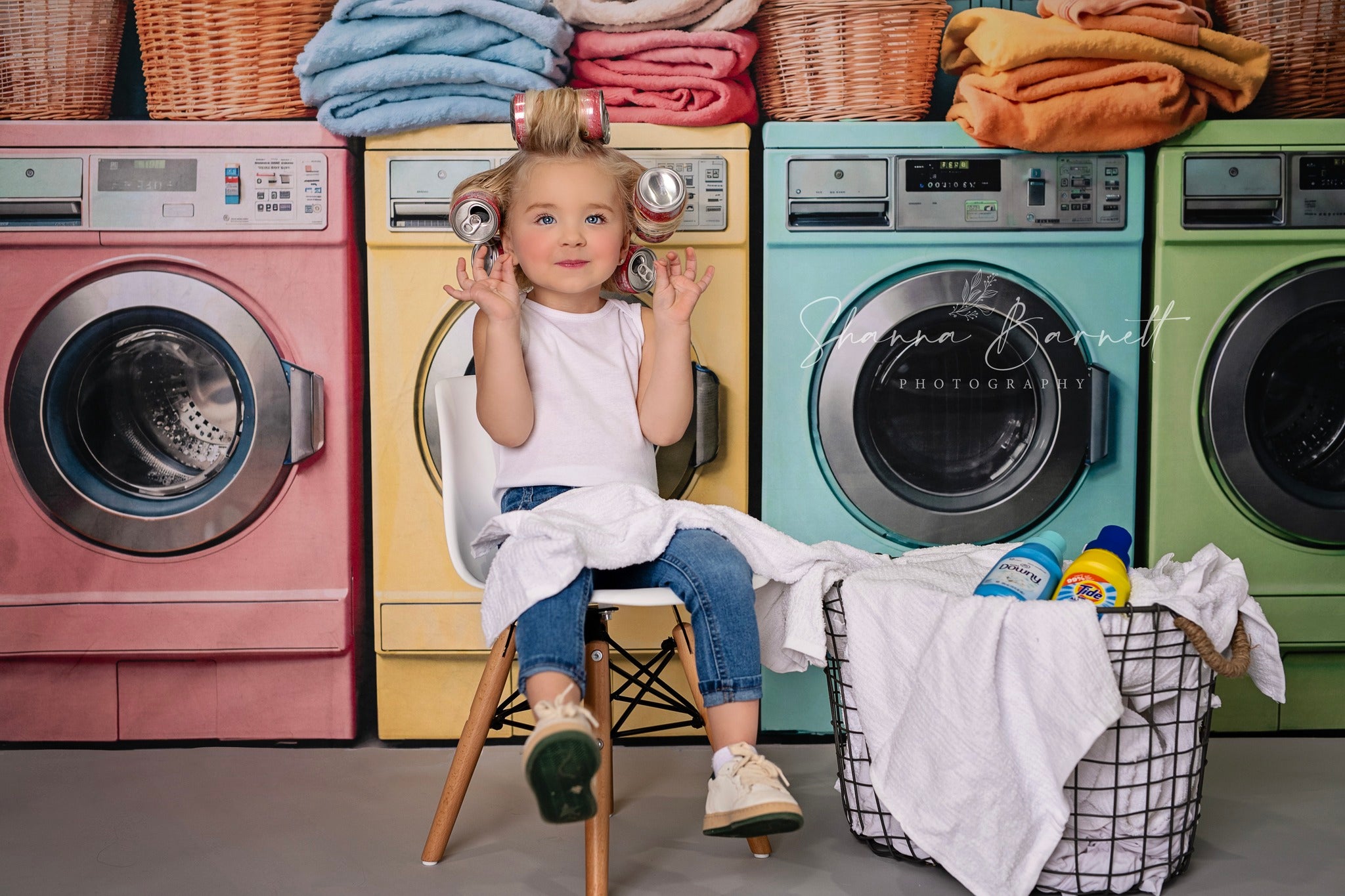 Girl sitting in front of washing machine backdrop