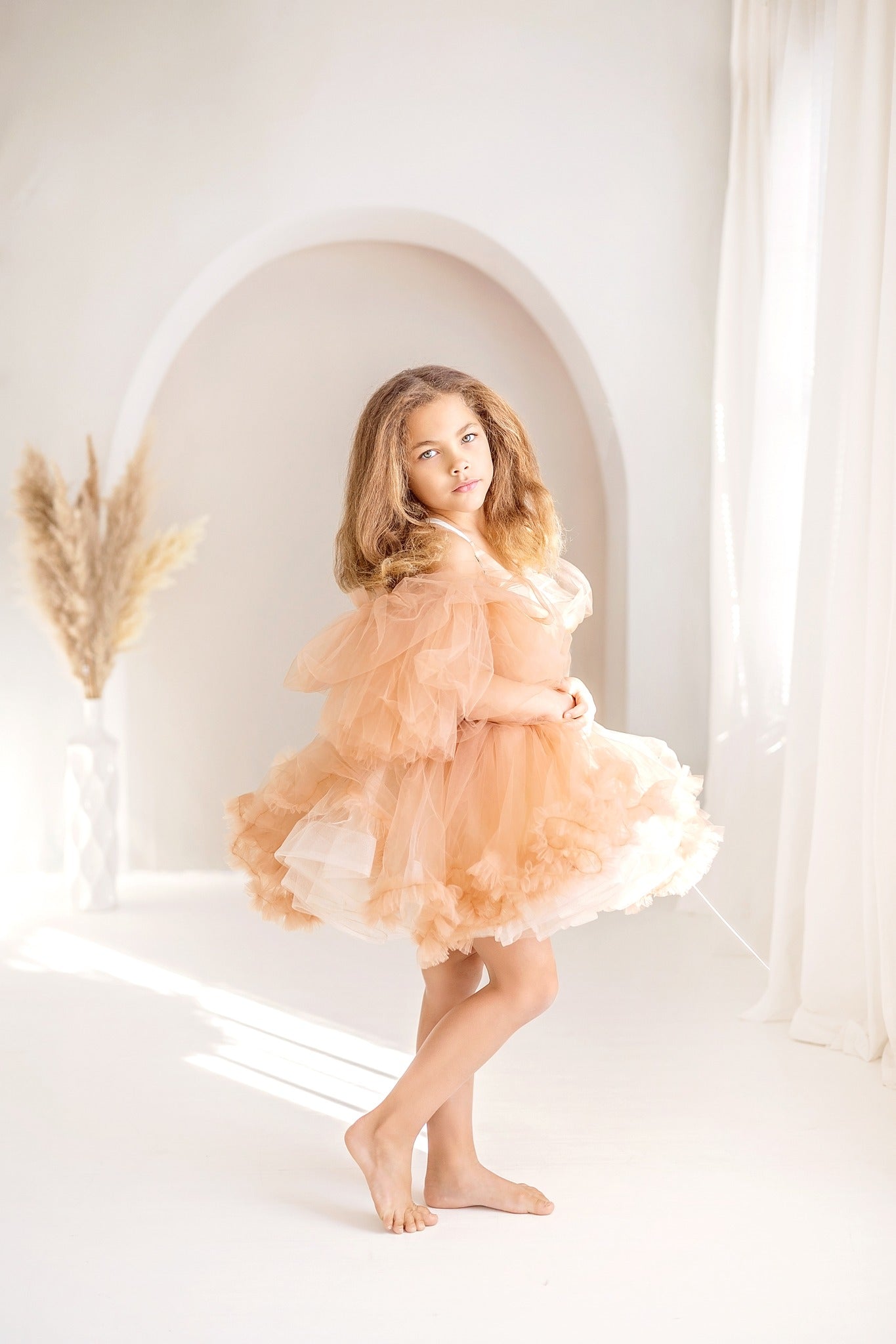 Girl wearing skirt standing in front of boho backdrop