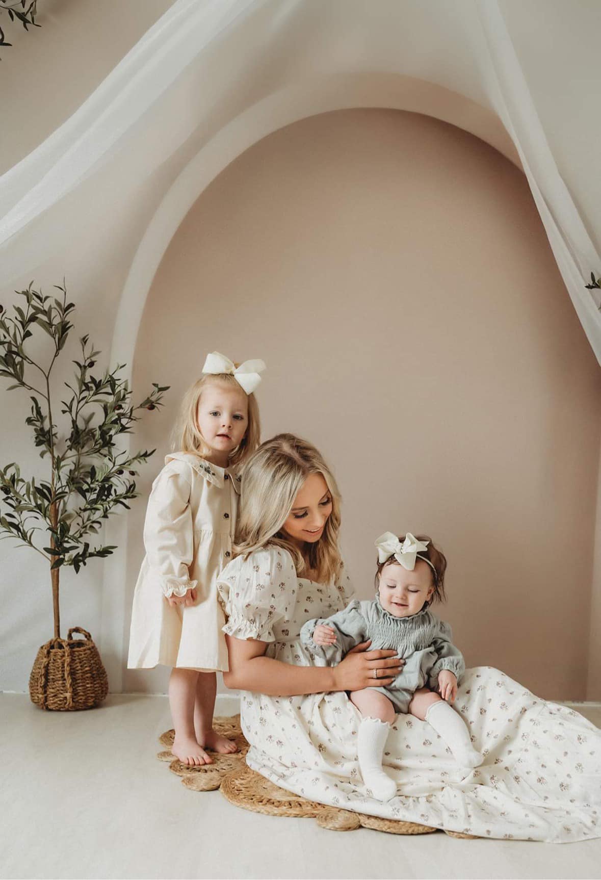 Mom and daughters in front of boho backdrop