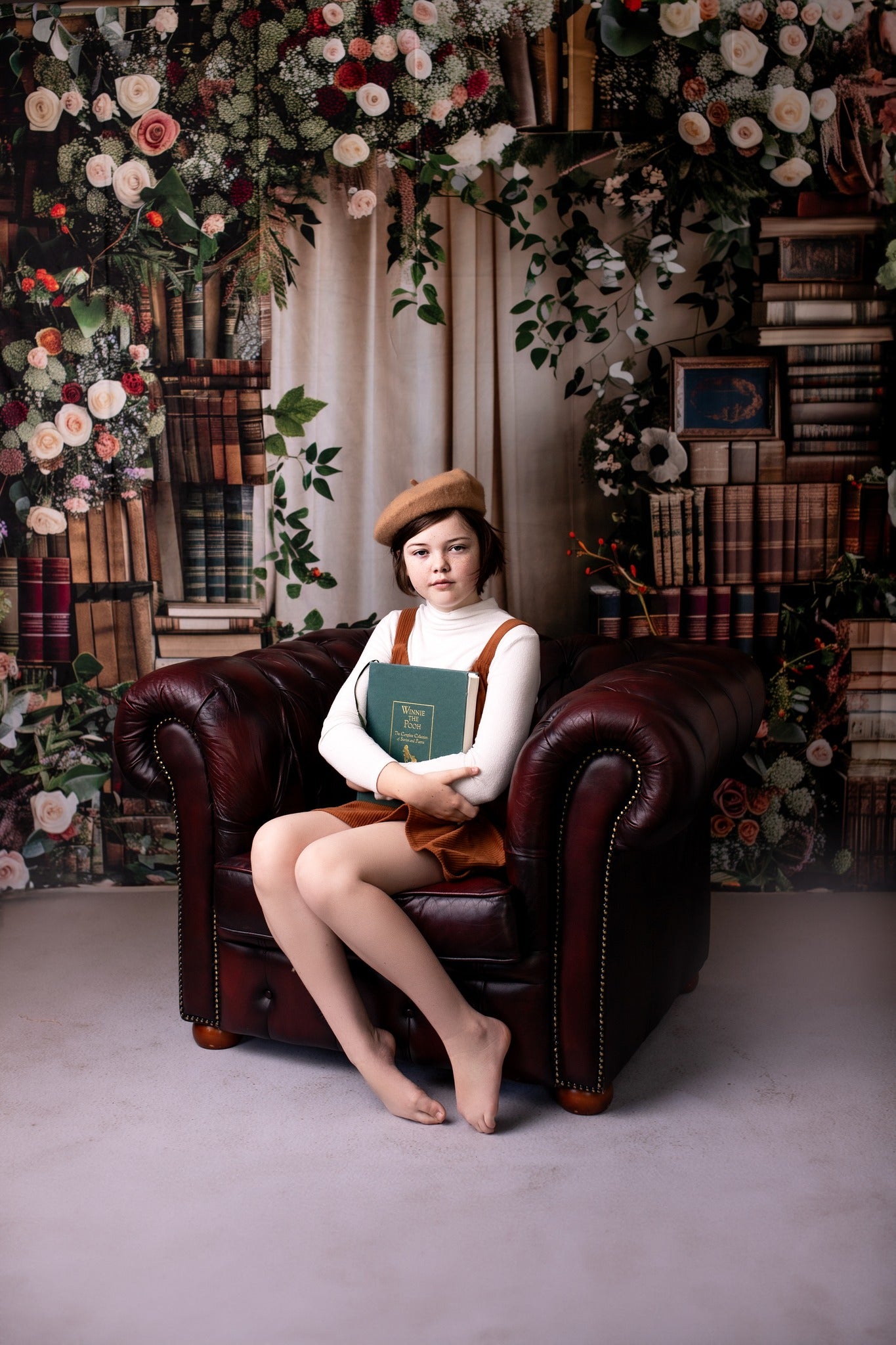 Girl sitting in front of spring back to school backdrop