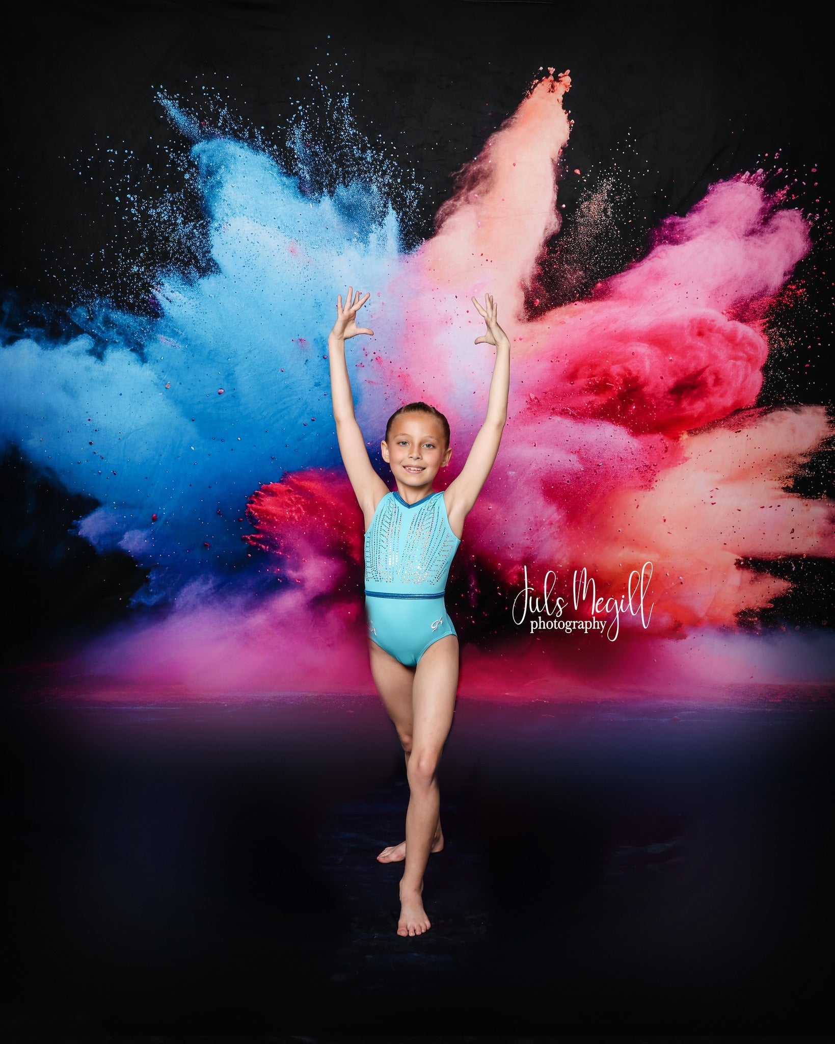 Girl dancing in front of colorful burst of powder fabric backdrop