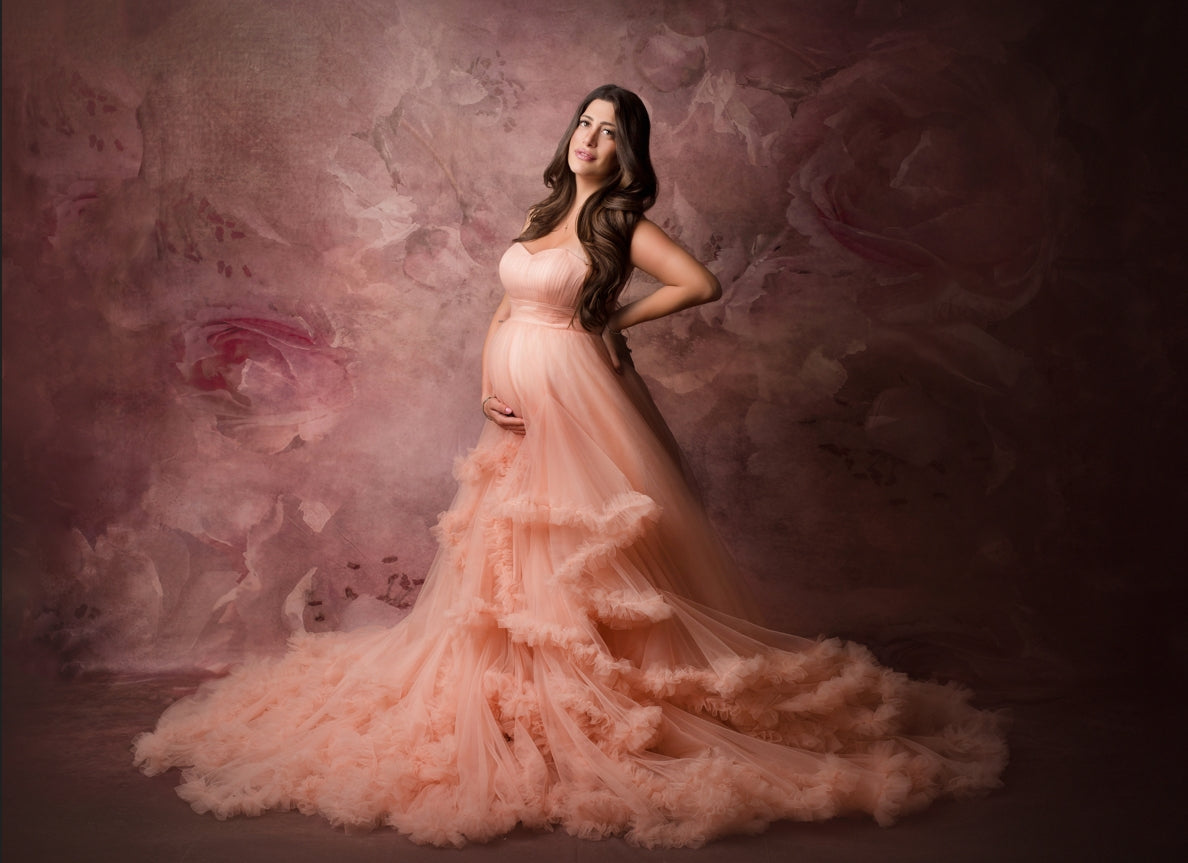 Pregnant mother standing in front of Fine Art Flower Backdrop