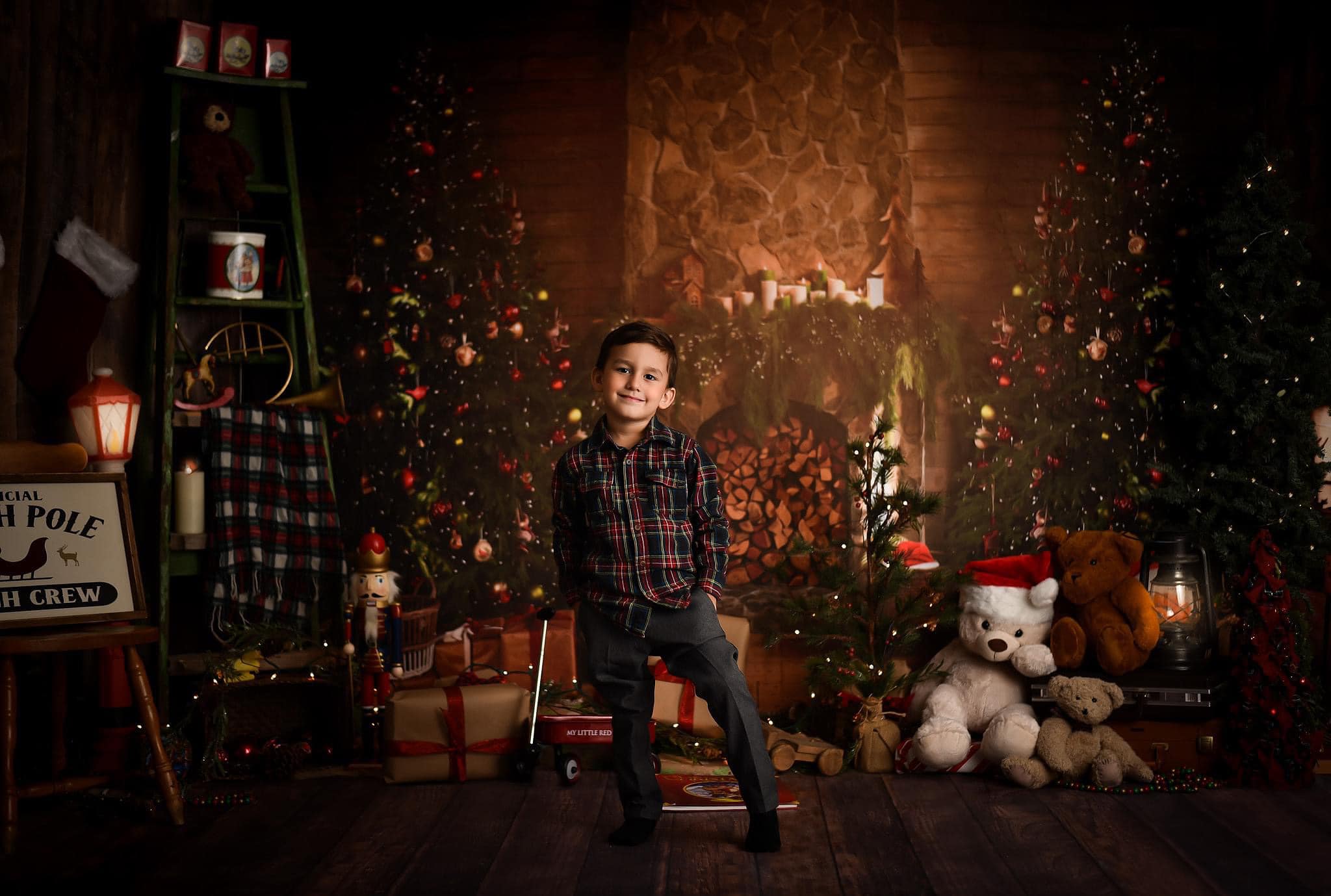 Little boy with hands in pockets standing in front of Christmas Tree Fireplace Indoor Backdrop