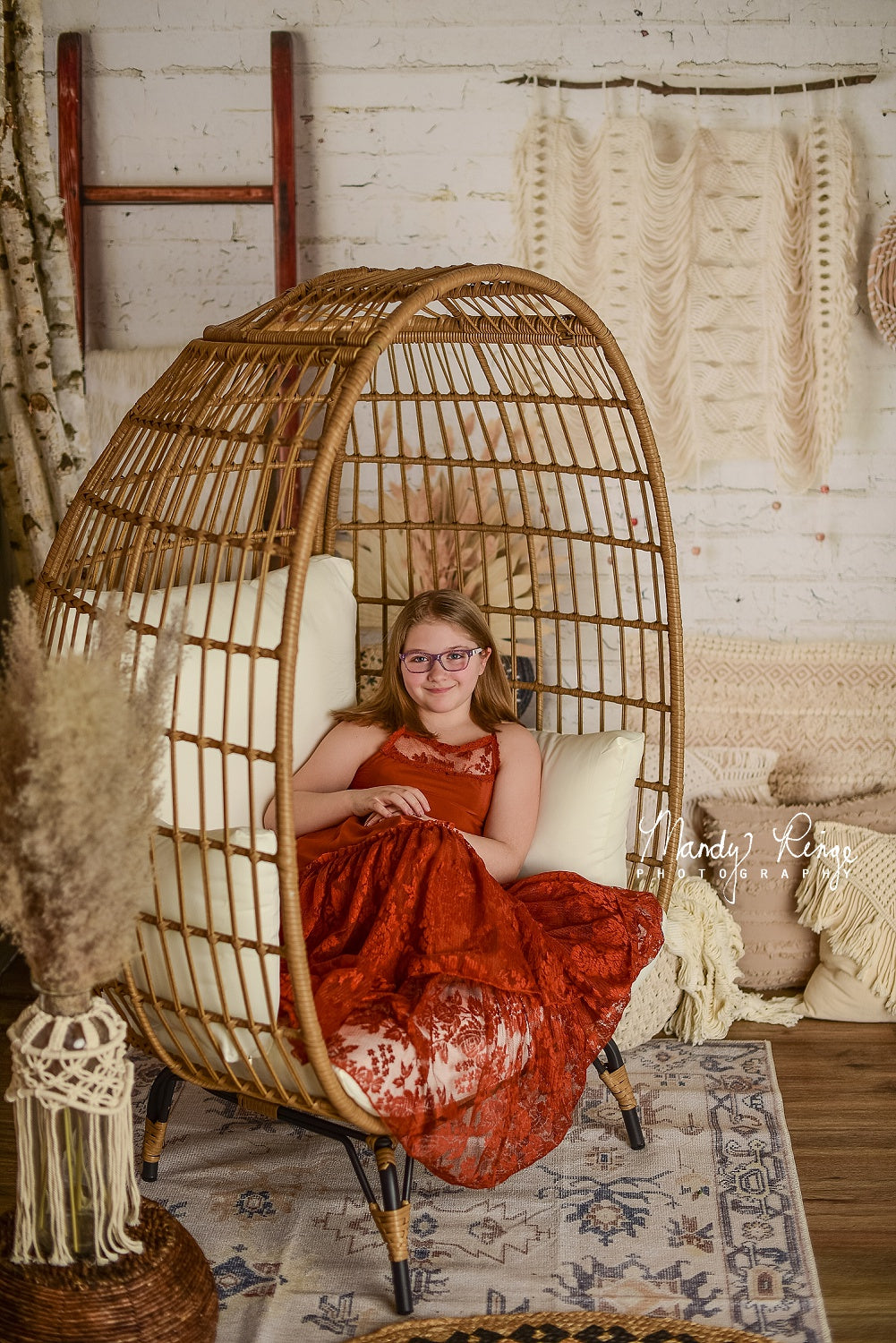 Girl lying in cradle in front of Boho Macrame Wall Backdrop